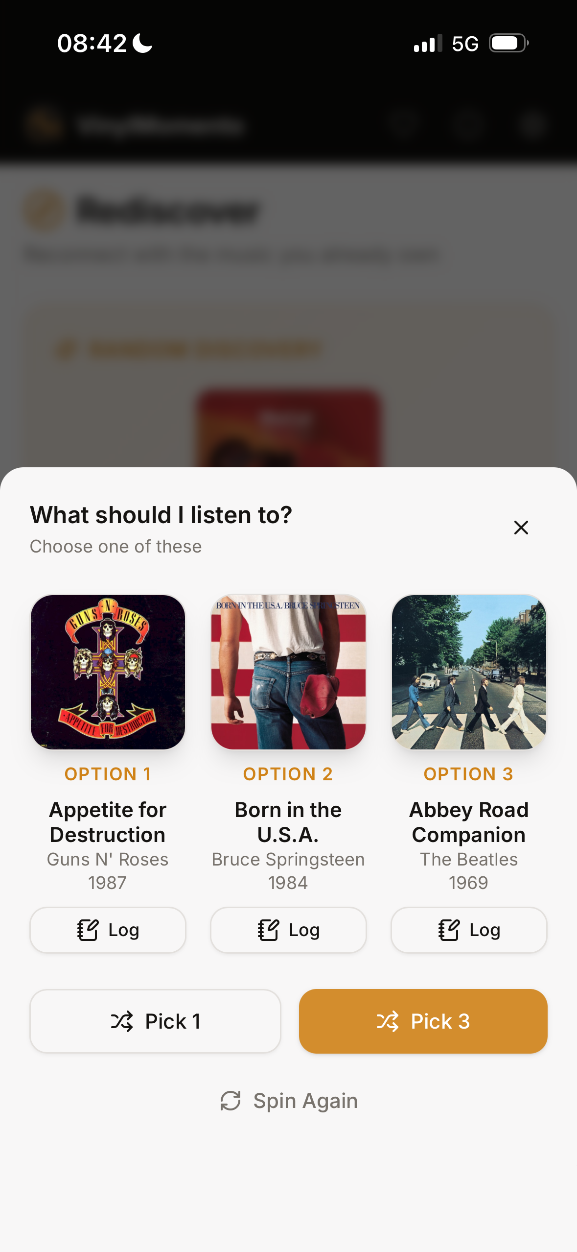 The VinylMomento randomizer suggesting three albums from the collection, each with a Log button.